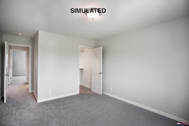 unfurnished bedroom featuring baseboards and carpet flooring