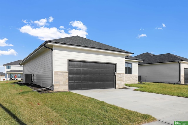 view of front of house featuring driveway, stone siding, an attached garage, central air condition unit, and a front yard