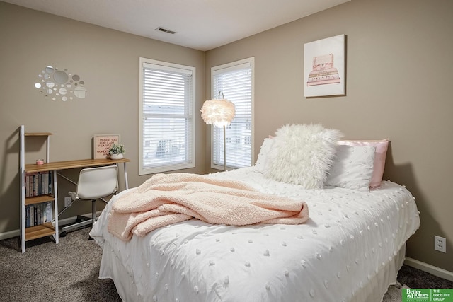 carpeted bedroom with baseboards and visible vents