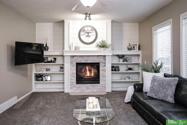 carpeted living room with baseboards, visible vents, and a tiled fireplace