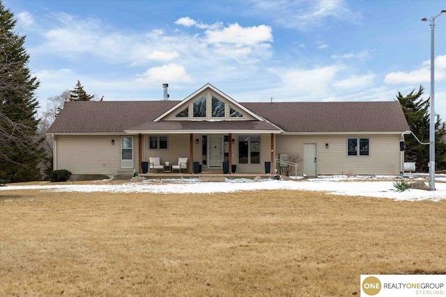 view of front of house with covered porch and a lawn