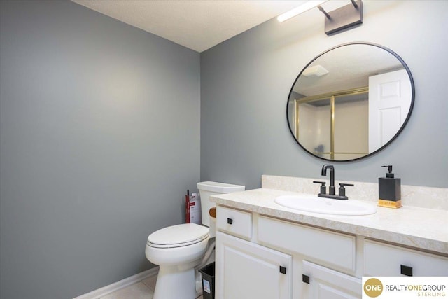 bathroom with vanity, toilet, and tile patterned flooring