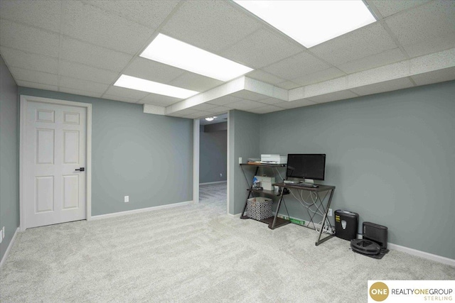 office area with carpet, baseboards, and a drop ceiling