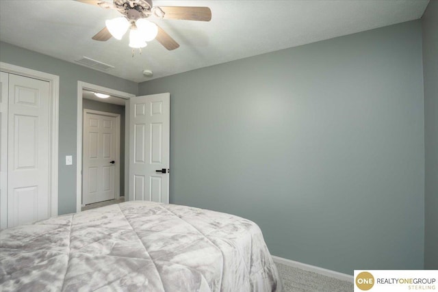 bedroom with visible vents, a closet, carpet, baseboards, and ceiling fan