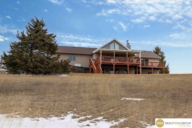 rear view of house featuring a deck and a chimney