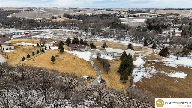 snowy aerial view featuring a rural view