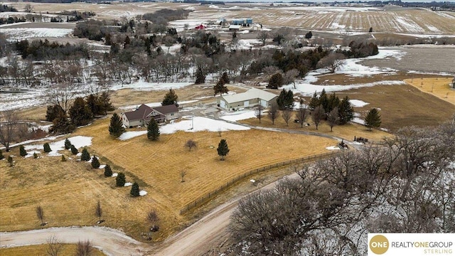 snowy aerial view featuring a rural view