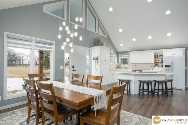 dining space featuring dark wood-style floors, recessed lighting, and high vaulted ceiling