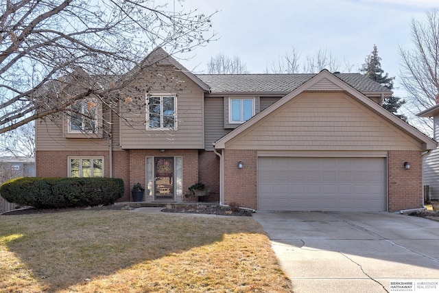 view of front of home featuring a shingled roof, concrete driveway, an attached garage, a front lawn, and brick siding