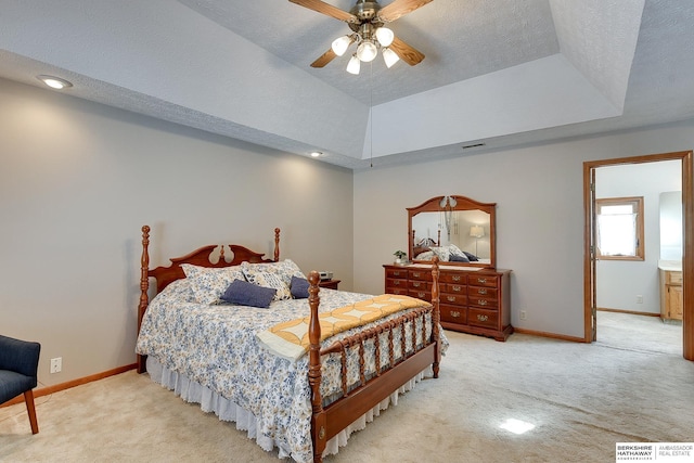 carpeted bedroom with visible vents, baseboards, a raised ceiling, and a textured ceiling