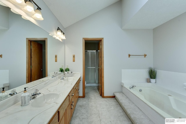 bathroom with double vanity, a stall shower, a sink, vaulted ceiling, and a bath