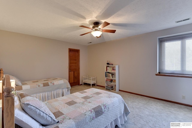 bedroom with baseboards, visible vents, and light colored carpet