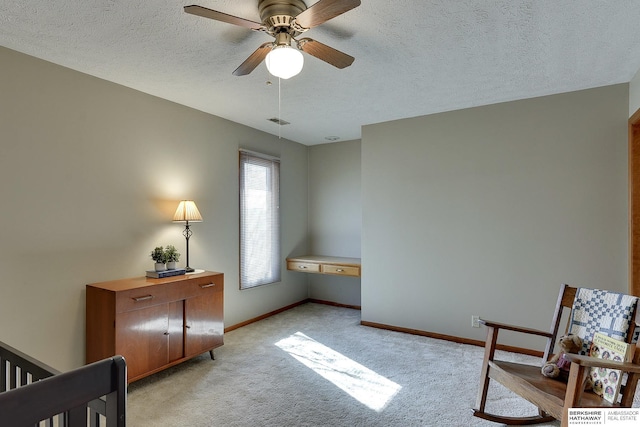 bedroom with light carpet, visible vents, baseboards, and a textured ceiling