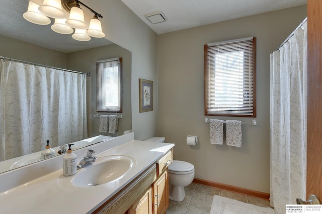 full bath featuring a healthy amount of sunlight, tile patterned flooring, baseboards, and vanity