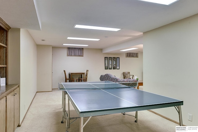 recreation room with light carpet and baseboards