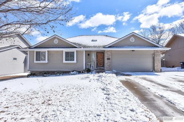 ranch-style home featuring a garage, brick siding, and driveway