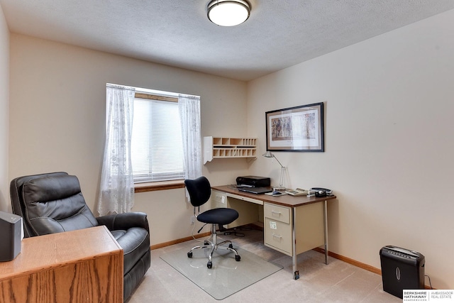 carpeted home office with a textured ceiling and baseboards