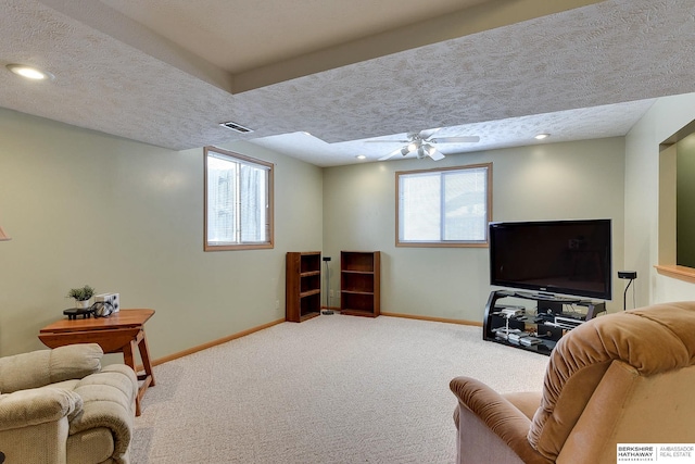 carpeted living area with visible vents, baseboards, a textured ceiling, and recessed lighting