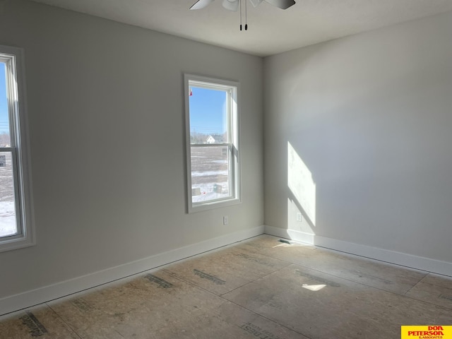 unfurnished room featuring baseboards, ceiling fan, and a healthy amount of sunlight