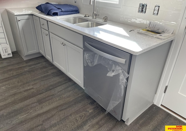 kitchen with decorative backsplash, dark wood-style flooring, a sink, and dishwasher