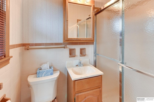 full bathroom with toilet, a stall shower, and vanity