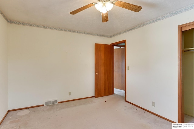 unfurnished bedroom featuring visible vents, light carpet, and baseboards