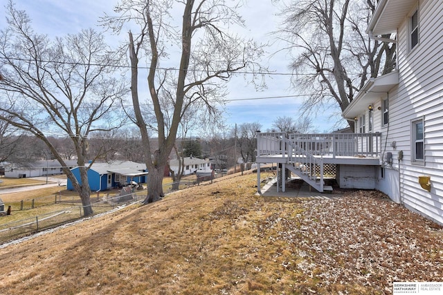 view of yard with stairway, a wooden deck, and fence