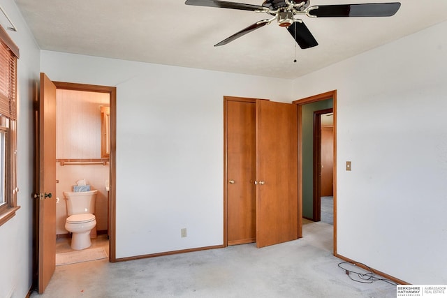 bedroom with connected bathroom, baseboards, light colored carpet, and a ceiling fan