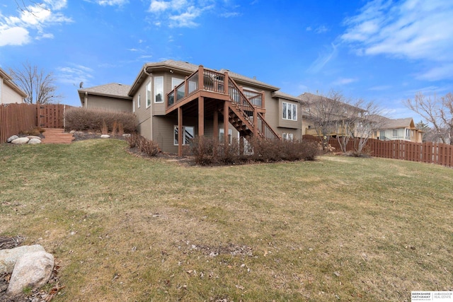 back of house with a wooden deck, stairway, a fenced backyard, and a lawn