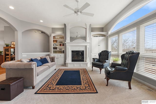 living area featuring a tile fireplace, recessed lighting, carpet floors, visible vents, and a ceiling fan