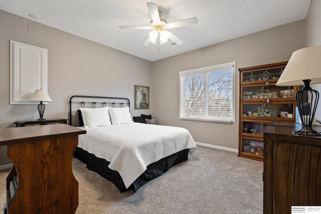 bedroom featuring a ceiling fan, carpet, and baseboards