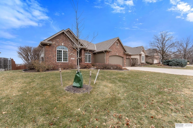 ranch-style home featuring a garage, brick siding, fence, concrete driveway, and a front yard