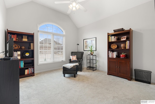 living area with carpet floors, ceiling fan, baseboards, and lofted ceiling