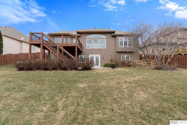 rear view of property with fence private yard, a yard, french doors, stairway, and a wooden deck