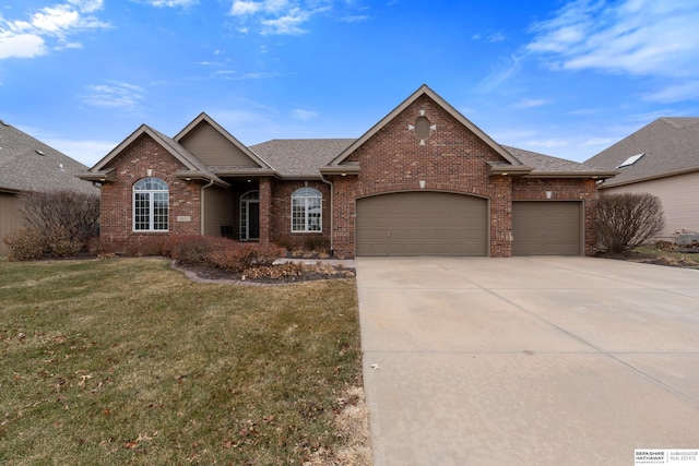 ranch-style house with brick siding, a shingled roof, an attached garage, a front yard, and driveway