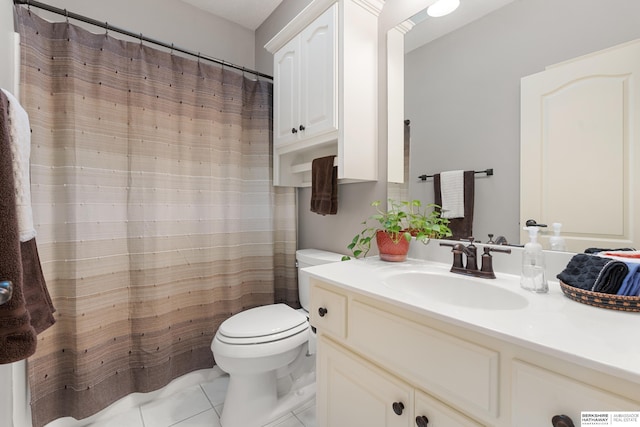 bathroom with tile patterned flooring, a shower with curtain, vanity, and toilet