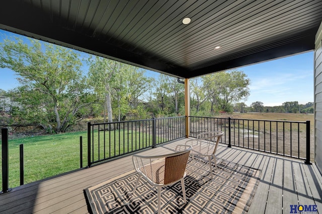 wooden terrace with a lawn