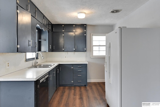 kitchen with dishwasher, dark wood-style flooring, light countertops, white fridge with ice dispenser, and a sink