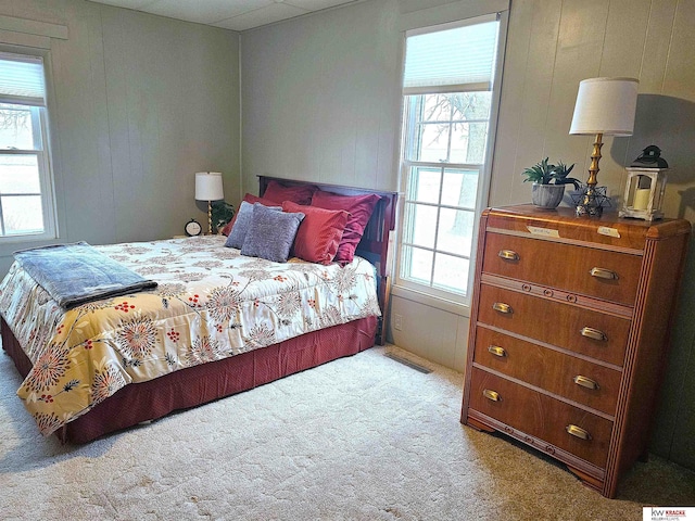 bedroom with multiple windows and carpet flooring