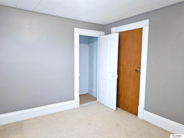 unfurnished bedroom featuring baseboards and carpet flooring