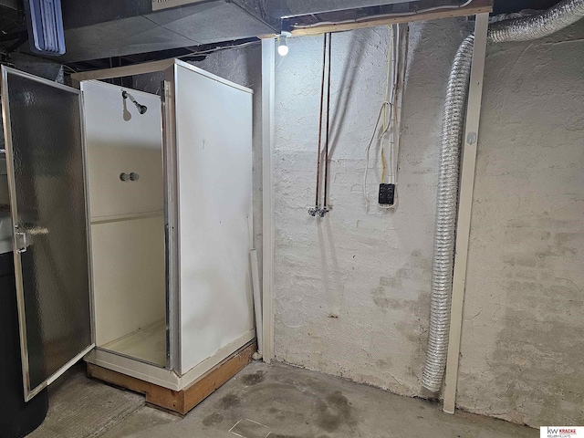 bathroom featuring a shower stall and unfinished concrete floors