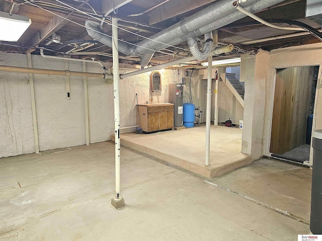 unfinished basement with water heater and stairs