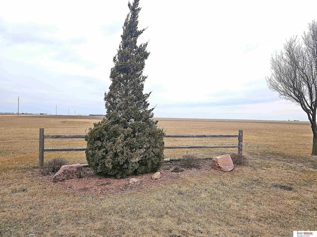 view of yard featuring a rural view and fence