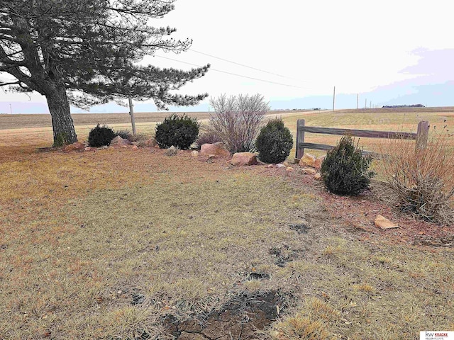 view of yard featuring a rural view and fence