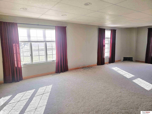 unfurnished room with visible vents, baseboards, a paneled ceiling, and carpet