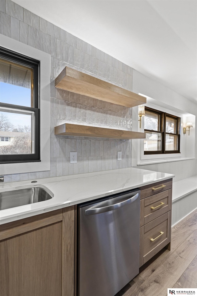 kitchen featuring light wood-style flooring, a sink, backsplash, dishwasher, and open shelves