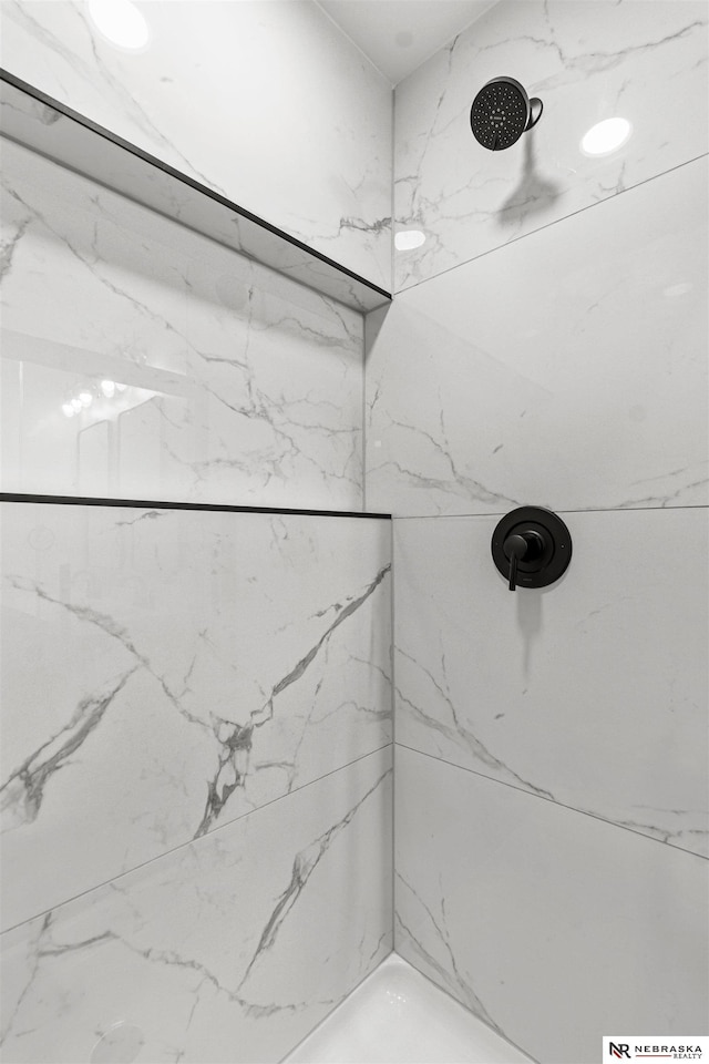 full bath with a marble finish shower