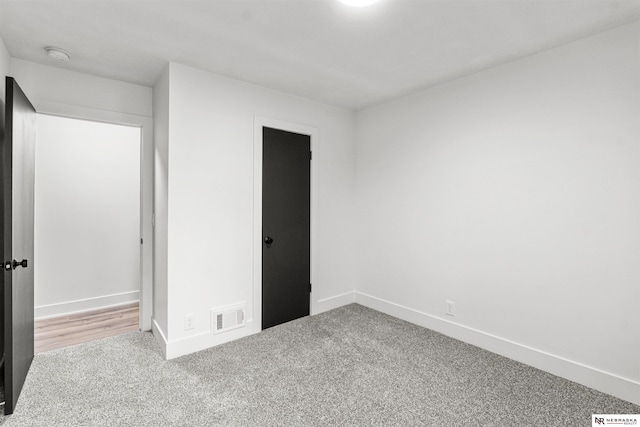 unfurnished bedroom featuring carpet, visible vents, and baseboards