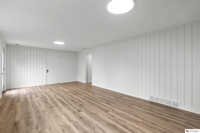 spare room with visible vents and wood finished floors