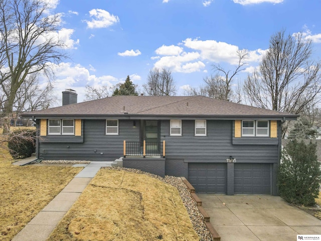 ranch-style house with a garage, brick siding, a shingled roof, concrete driveway, and a chimney